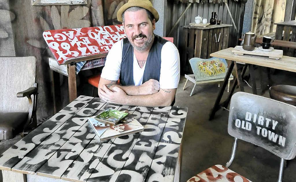 Johnny Thompson, owner of Dirty Old Town at Federal, with his home-made, hand-cut stencil. Johnny Thompson, owner of Dirty Old Town at Federal, with his home-made, hand-cut stencil.